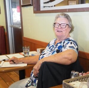 picture of woman seated at a table