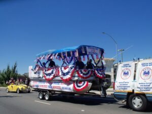 Picture of truck and pontoon boat decorated in red, white & blue with NARFE banners