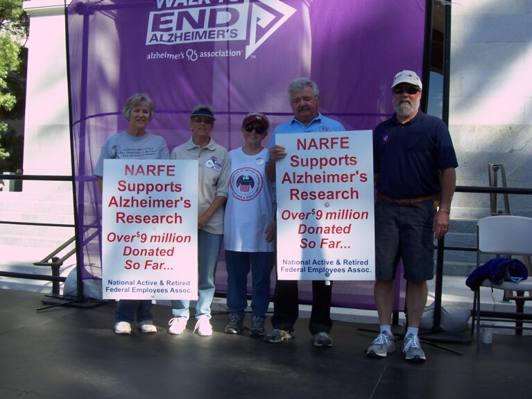 Photo of 5 NARFE members holding NARFE banners