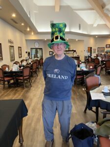 Man standing with large leprechaun hat and shirt that says Ireland