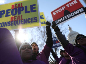 Protesters in front of Capitol with signs