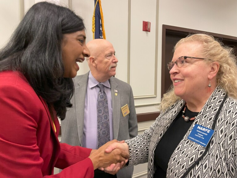 Lt. Gov. Aruna Miller shaking hands with Teresa Baker and NARFE National President William Shackelford