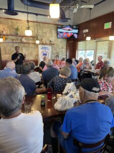 man talks to people in a restaurant