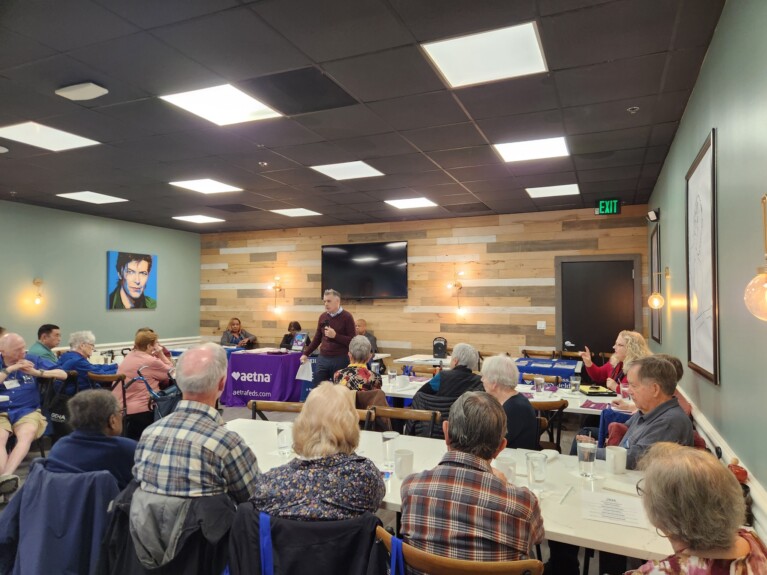man speaking to at luncheon