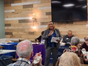 woman with microphone at open season lunch