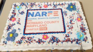 White frosted sheet cake with flowers, star sprinkles, and NARFE Chapter 1734 logo.