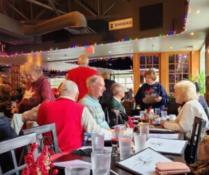 people gathering for holiday lunch at White Oak Tavern decorated for Christmas