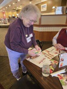 Woman standing by a table over menus