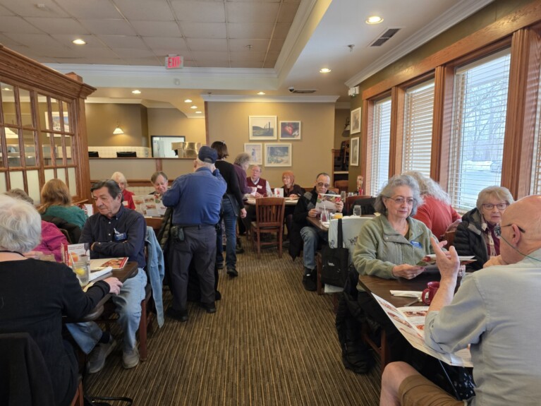 retirees at restaurant tables for lunch
