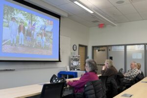 people in a classroom looking at a slide projection