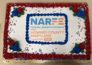 sheet cake with NARFE Chapter 1734 logo and white icing and red and blue flowers and star sprinkles