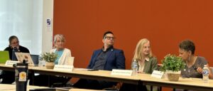 5 legislators at a long table