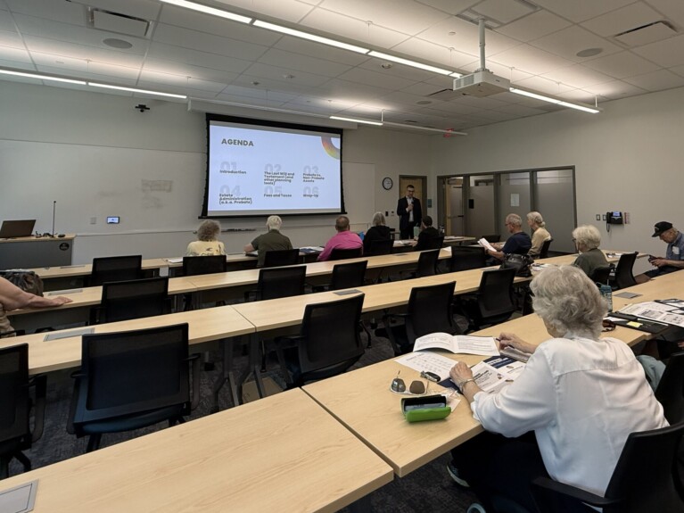 man in front of classroom with agenda on screen