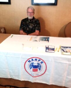 Chapter member sitting at recruitment table in Louisville, KY