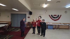 Picture of three people being sworn in as chapter officers by a federation officer