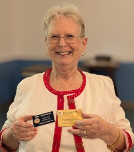 Ann Simpkins showing her mother's NARFE badge