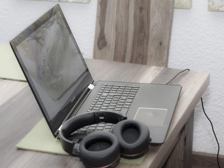 headset resting on top of laptop on table