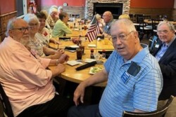 Picture of several people sitting around a table