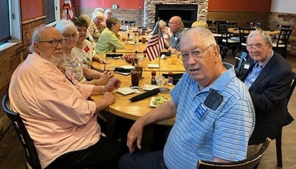 Picture of several people sitting around a table