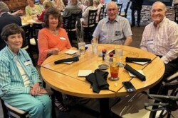 Picture of two men and two women sitting around a table