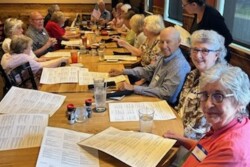 Picture of several people sitting around a lunch table