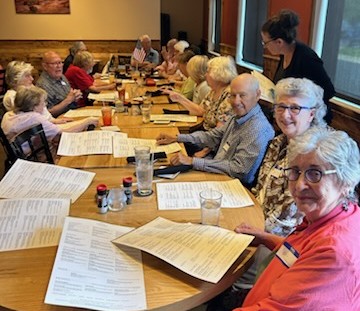 Picture of several people sitting around a lunch table