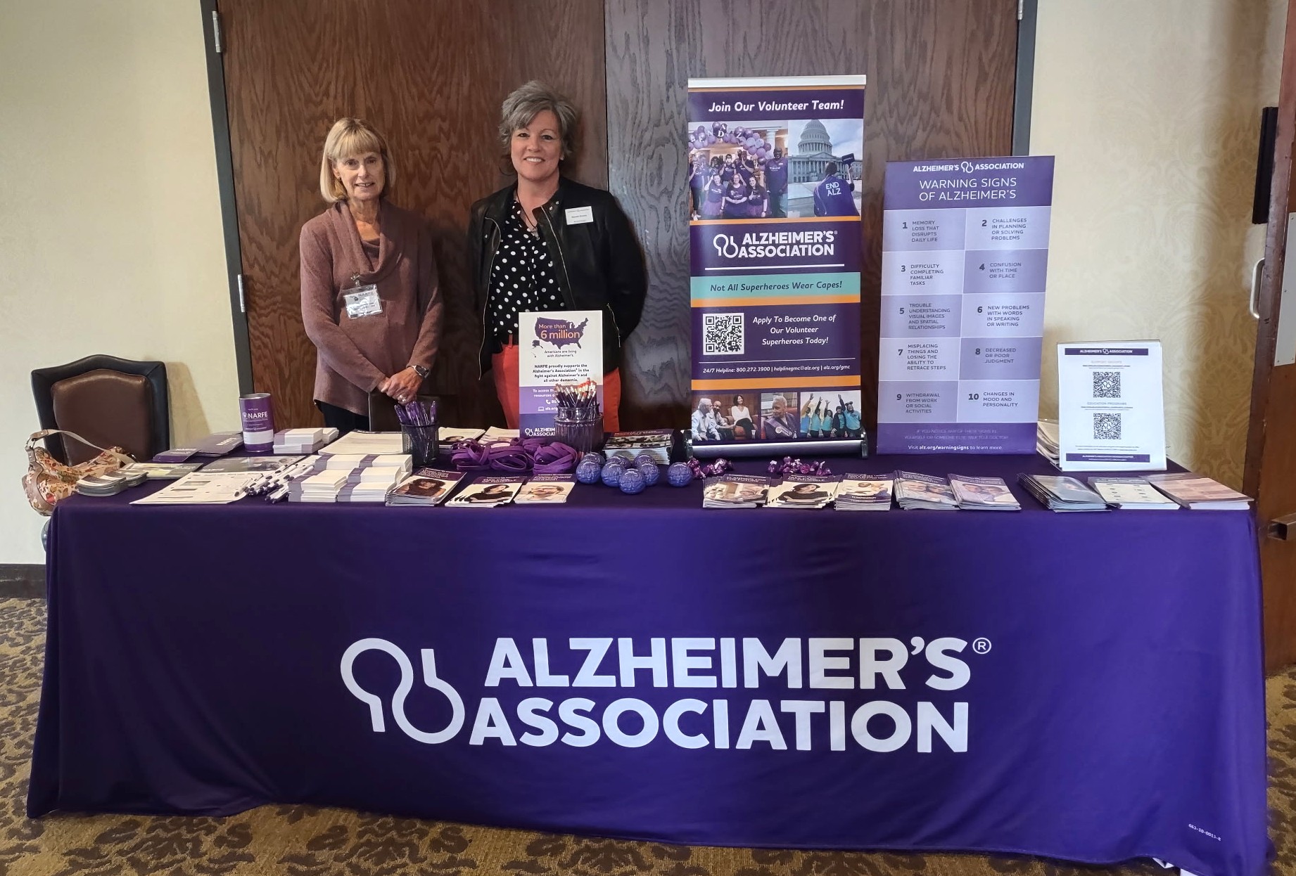Two Alzheimer Representatives standing by the display table