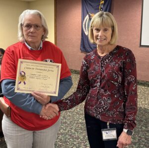 Chapter Member holding Alzheimer certificate presented to Chapter for second highest donation for the year