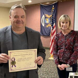 Chapter Member holding Alzheimer certificate presented to Chapter for highest donation for the year