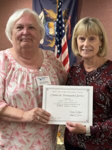 Two women holding Alzheimer certificate presented to Chapter for Walk to End Alzheimer