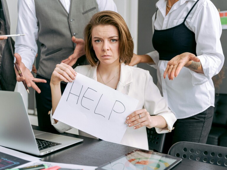 Person holding sign that says HELP