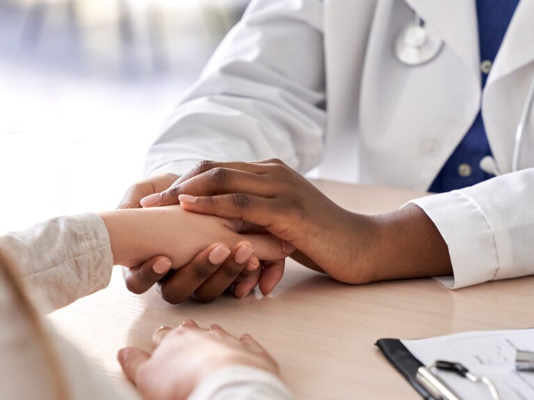 doctor holding patient's hand