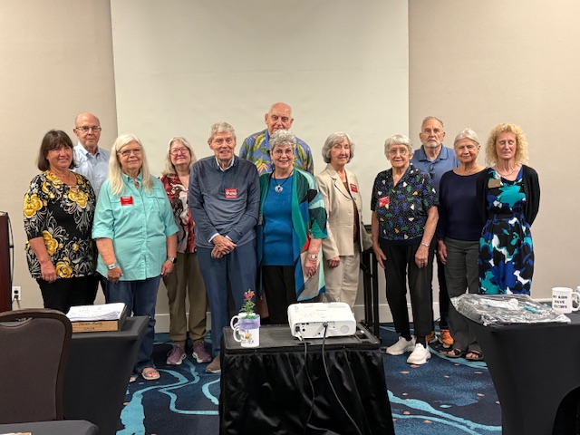 Group of people standing at the front of the room