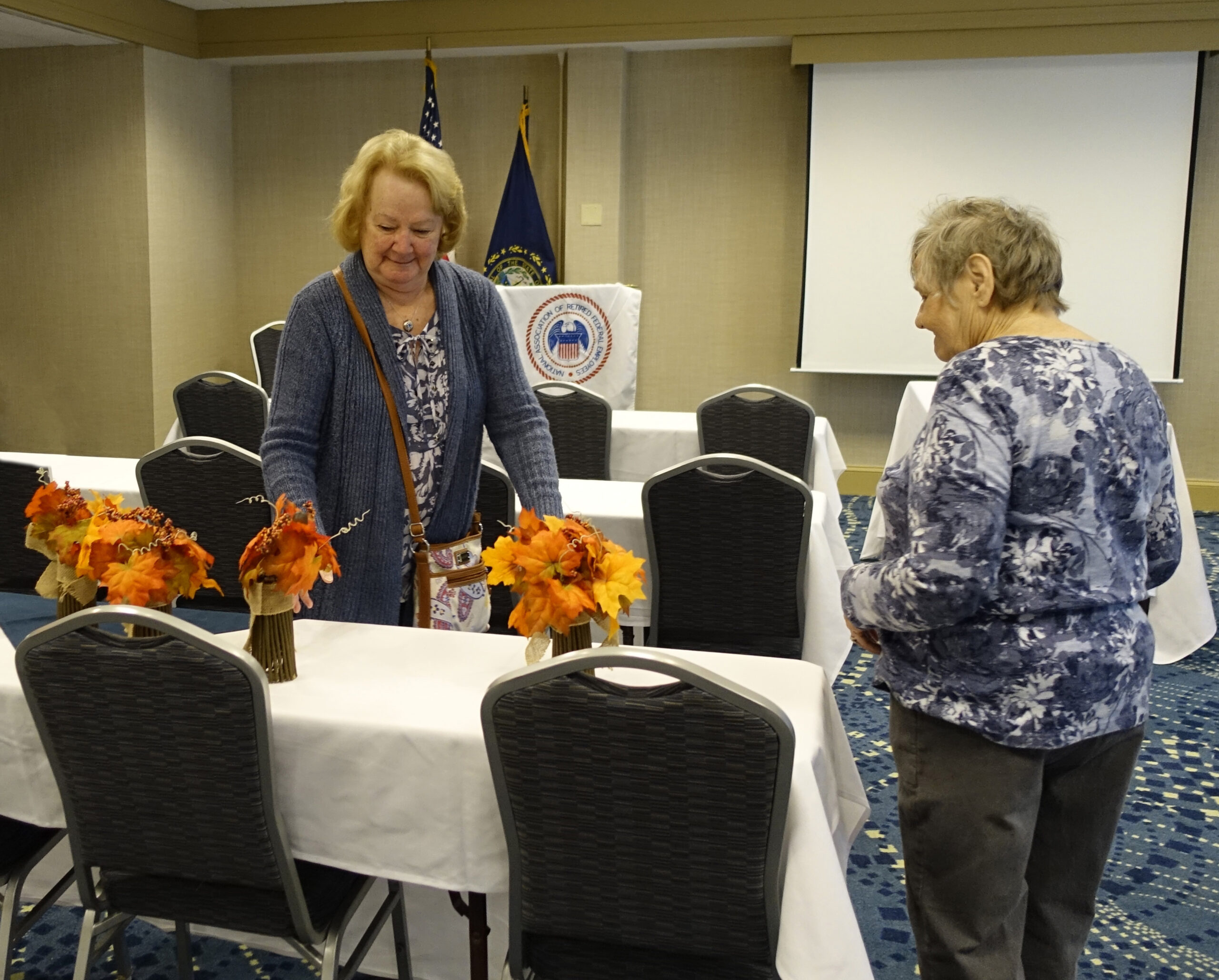 Two women and table with floral decorations