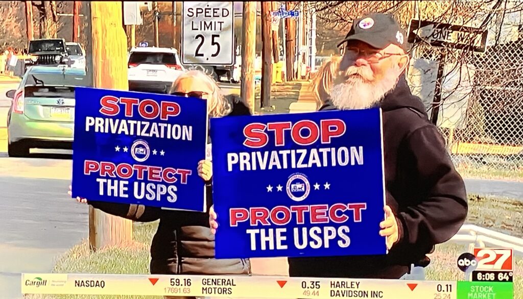 Two men with placards at a demonstration in Washington, DC, against privatization of the US Postal Service