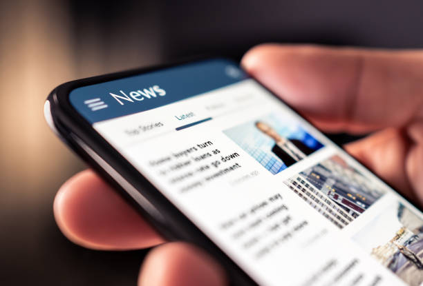 Cell phone displaying news articles