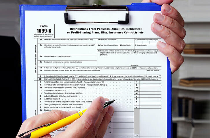 1099-R form on a clipboard