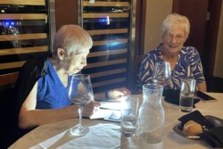 two women at a dining table ordering dinner