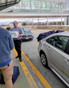 Photo of a stack of pizzas being delivered
