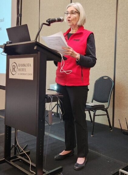 A woman from the AARP organization presents information on spamming