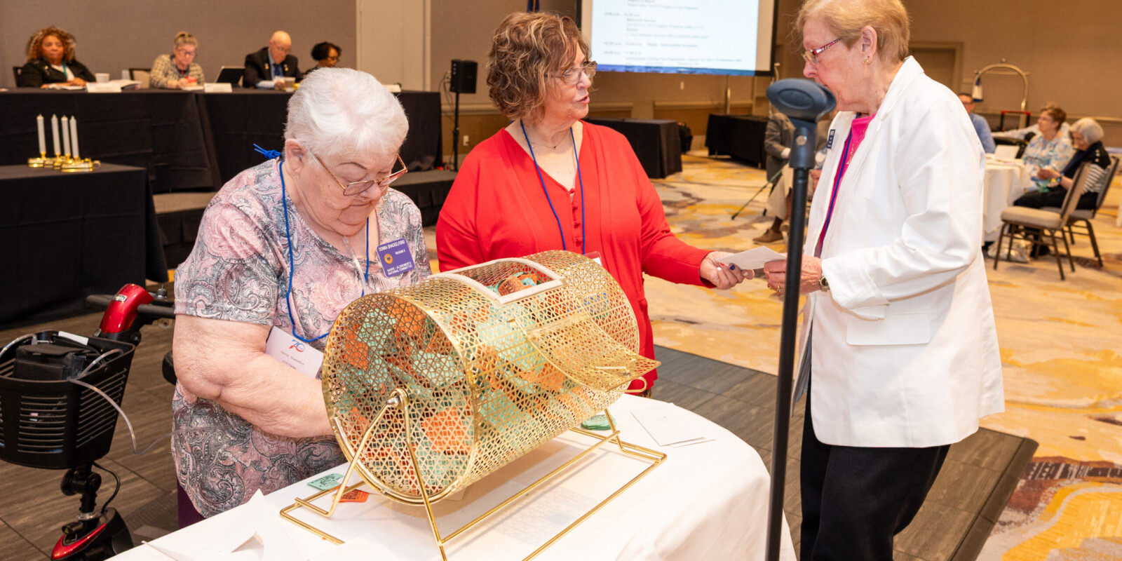At the VFN Conference it is time to draw names for the 50/50 raffle and a winners name has been pulled by the Alzheimer's Coordinator and her assistant