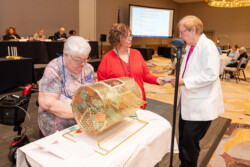 At the VFN Conference it is time to draw names for the 50/50 raffle and a winners name has been pulled by the Alzheimer's Coordinator and her assistant