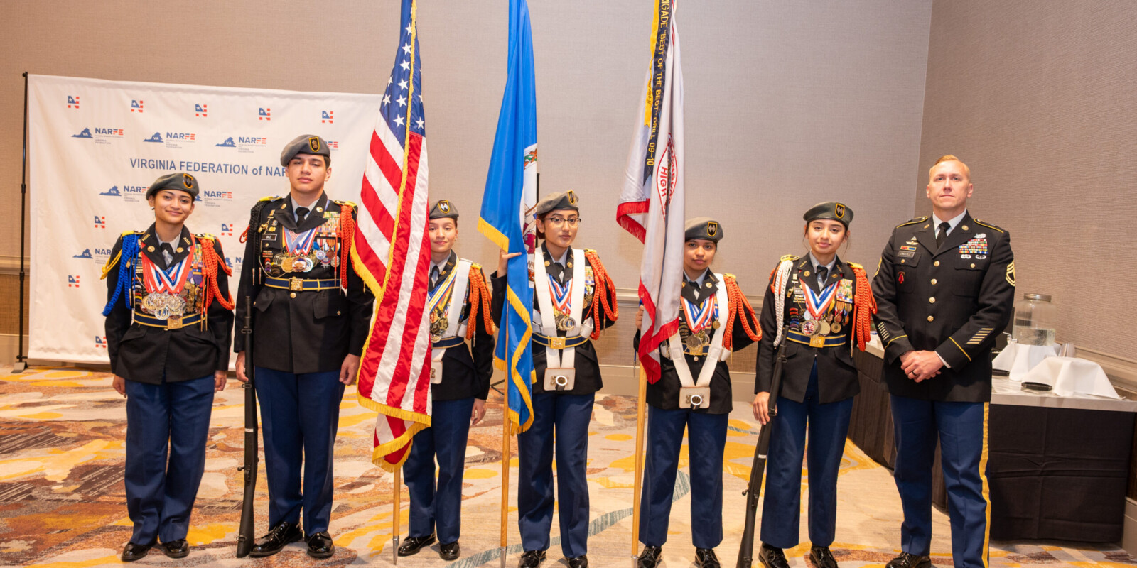 Harrisonburg Schools Honor Guard posing for a casual image with big smiles.