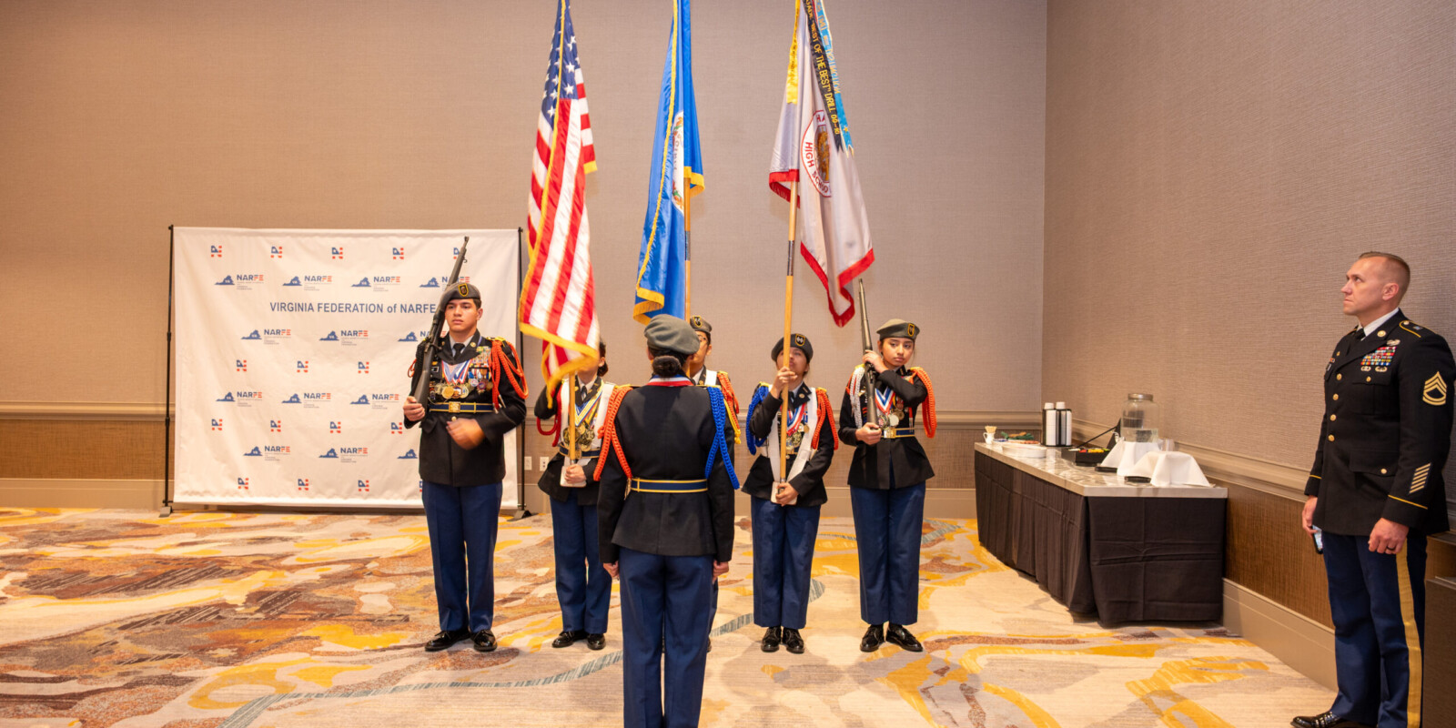 Harrisonburg Schools Honor Guard practicing before a presentiation with the U.S. Flag, the Commonwealth of Virginia Flag, and the Harrisonburg School Flag.