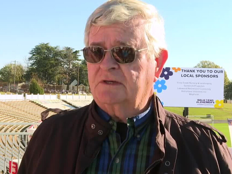 a man standing in a field with sun glasses on
